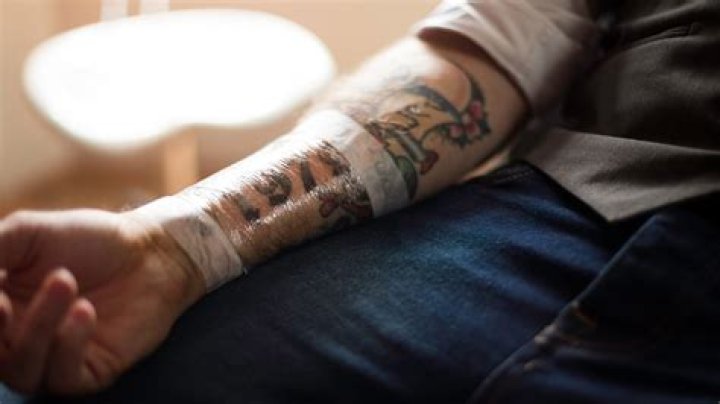 How do you treat an infected tattoo at home?